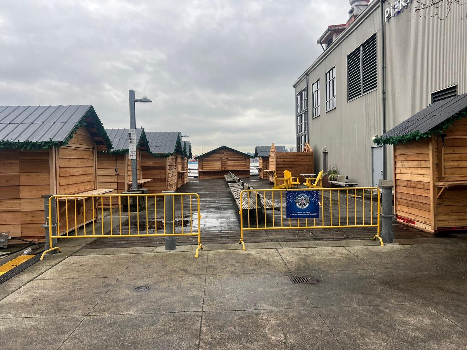 Installed cedar huts lining a waterfront market