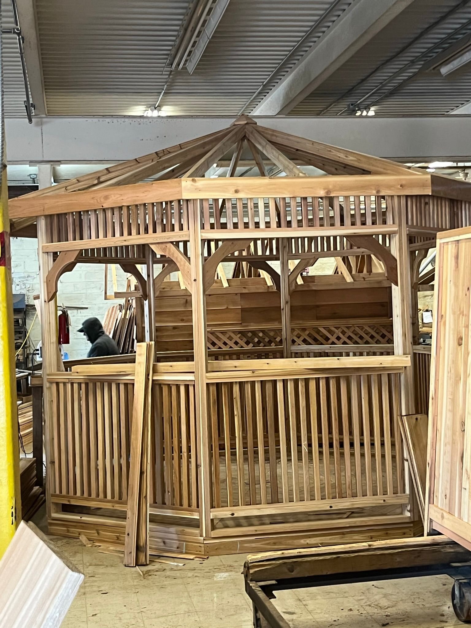 Cedar gazebo with lattice railings in the shop