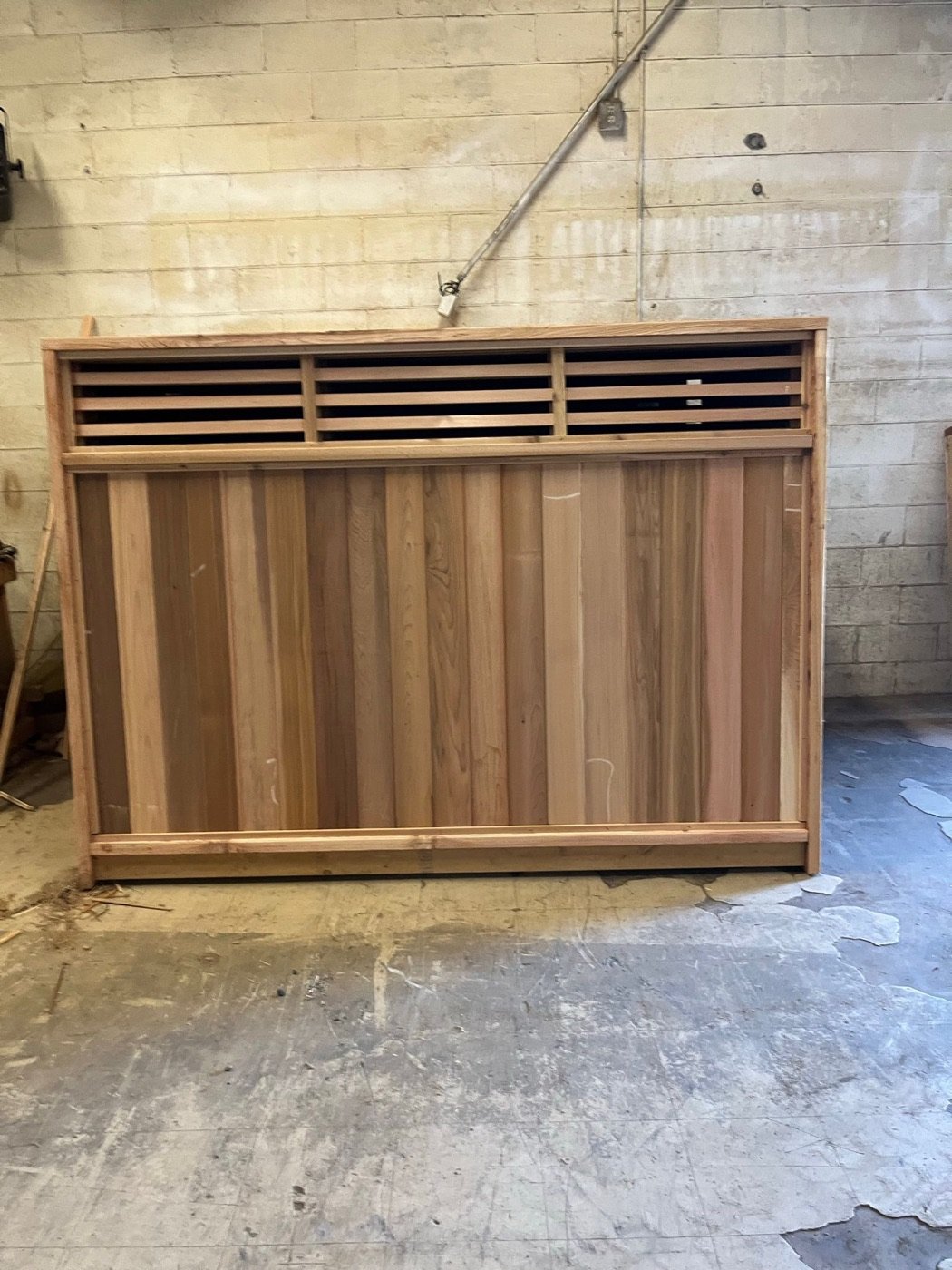 Cedar fence panel with horizontal slat detail at top