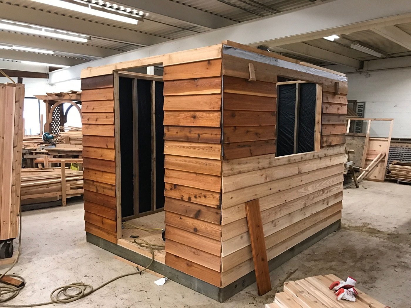 Cedar workshop shed with horizontal lap siding and window