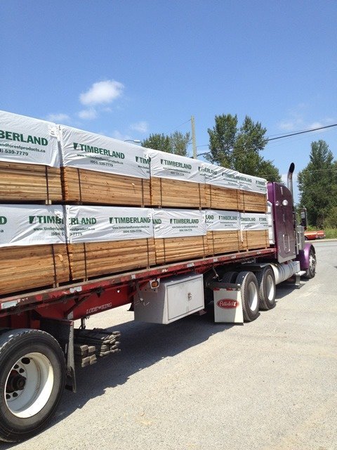 Timberland lumber delivery truck with branded packs